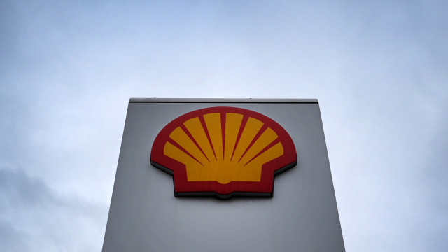 A Royal Dutch Shell sign is seen at a petrol station in London, Britain